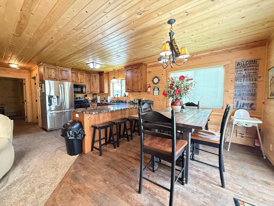 Gather everyone together at the rustic wooden dining table, complete with additional seating at the convenient kitchen breakfast bar stools.