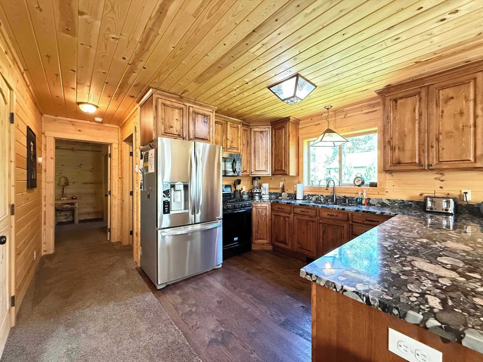 Whip up delicious family meals in the gourmet kitchen, beautifully finished with premium granite countertops, rich wood cabinetry, and stainless steel appliances.
