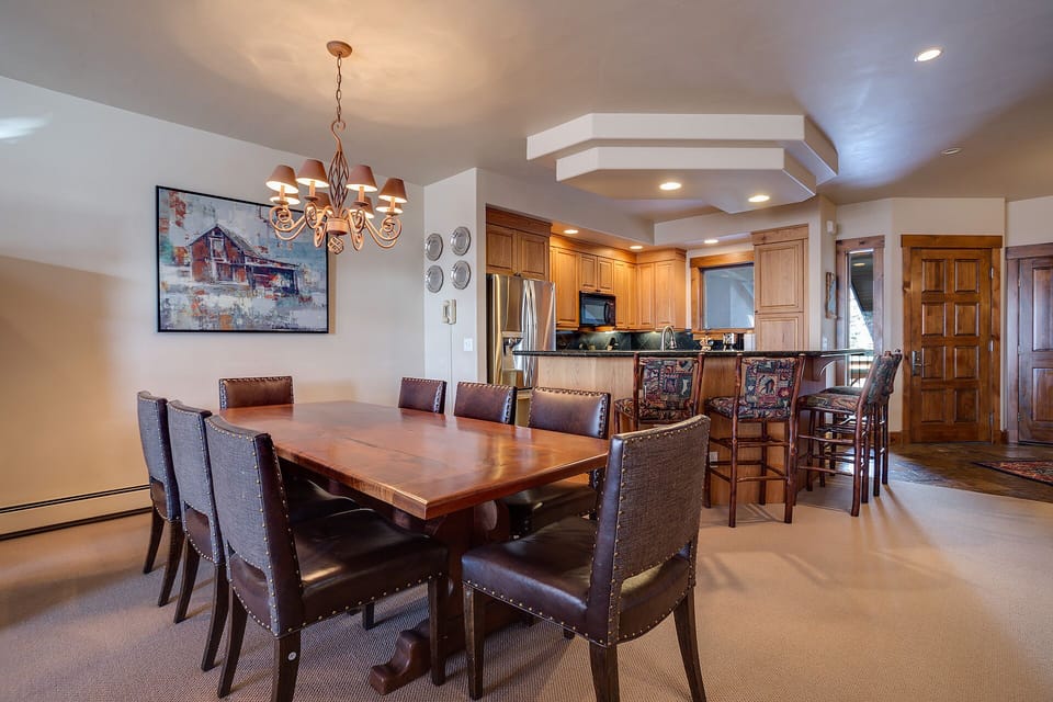 Gather around your spacious dining table for memorable meals with warm wood finishes and elegant lighting creating the perfect atmosphere for connection.