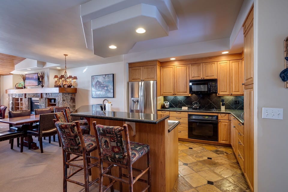 Your spacious kitchen features granite countertops, stainless appliances, and a breakfast bar perfect for morning coffee or evening gatherings.