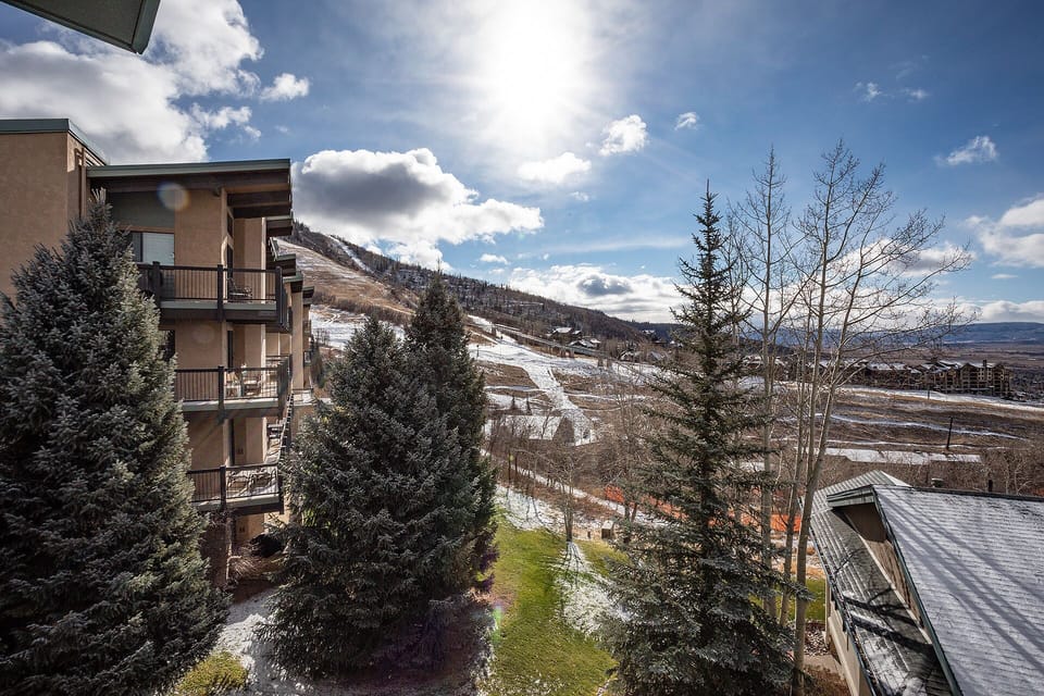 Mountain resort setting with ski slopes and scenic winter landscape visible from the property balconies.