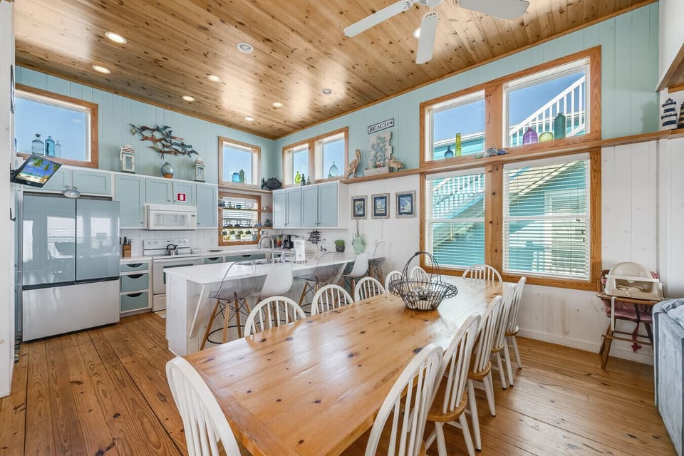 Gather around the table in this bright, coastal dining space.