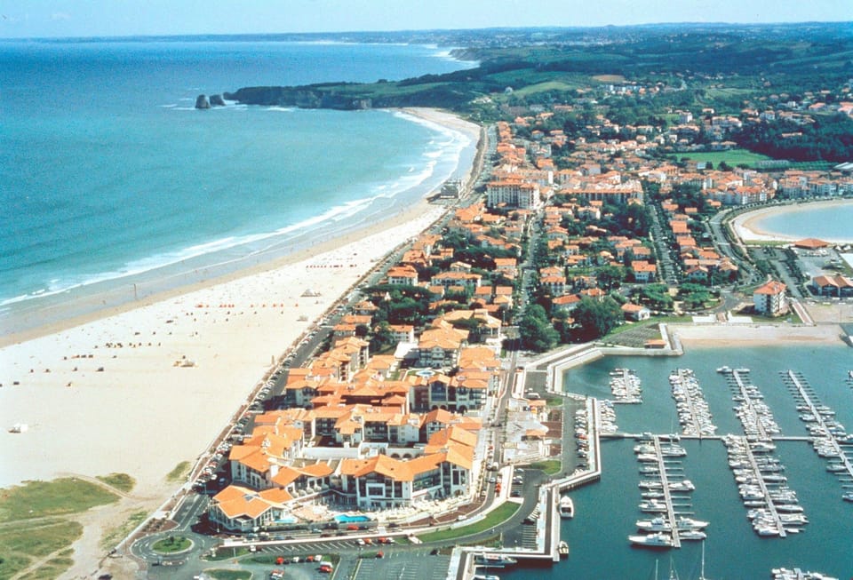 A long, sandy beach is found just outside your door