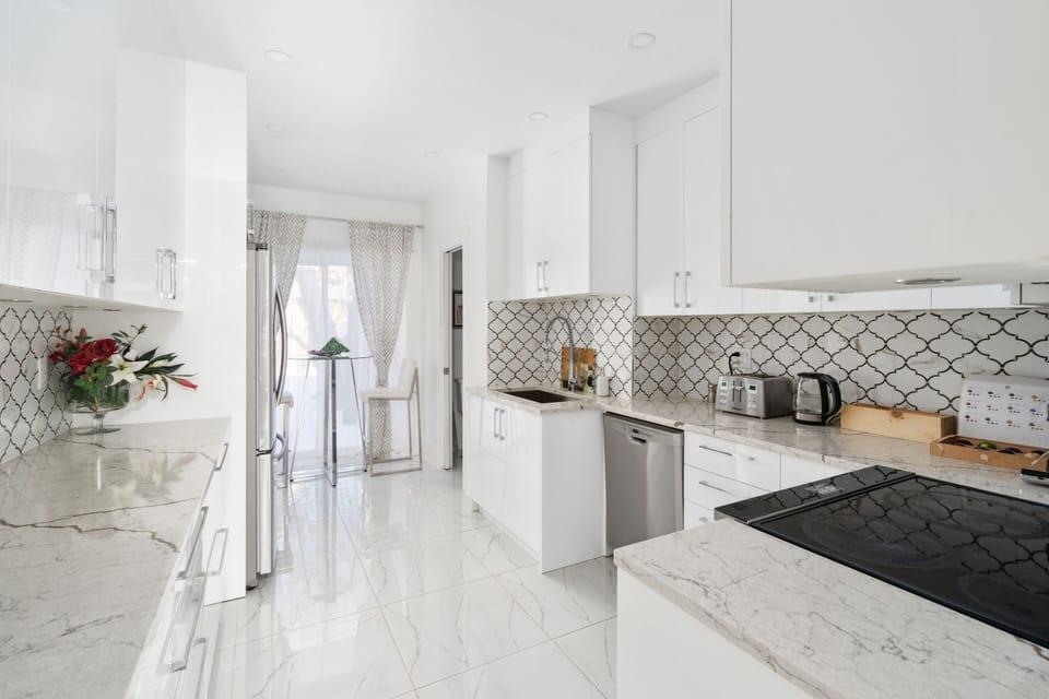 Impeccable kitchen leading to the breakfast nook and rear exit.