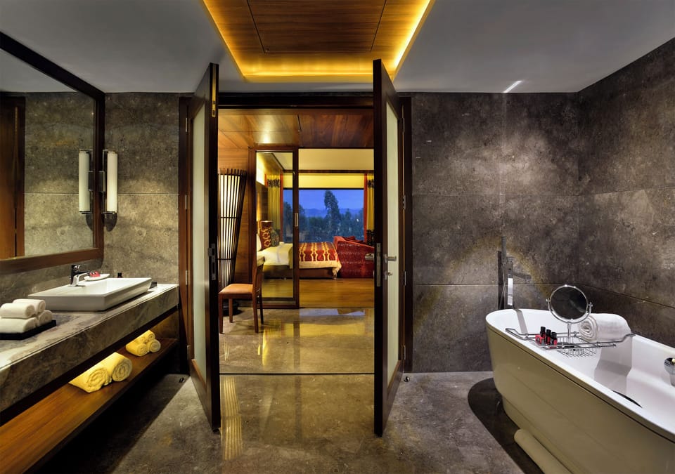 The Lalit Legacy Suite | Bathroom | Shower, hydromassage showerhead, designer toiletries, hair dryer