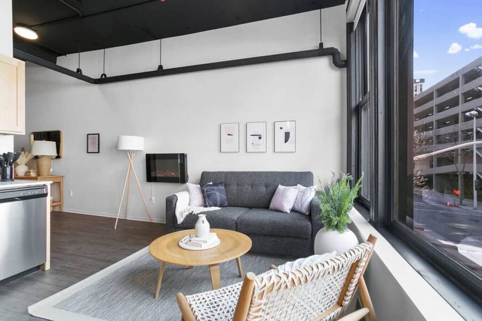 Sunlit living space with large windows and an open-concept layout.