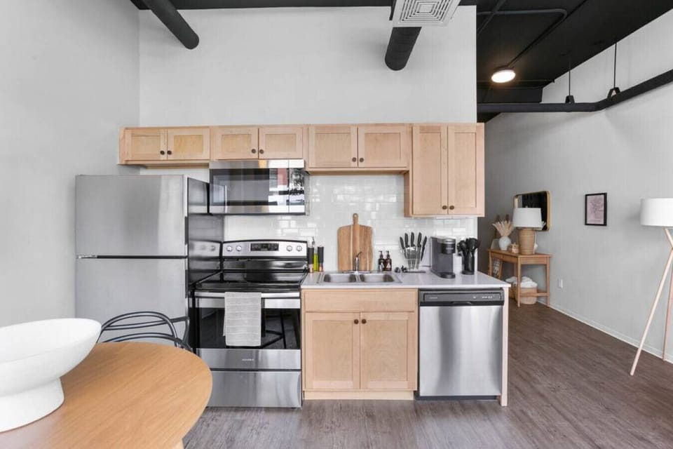 Sleek, fully stocked kitchen with high-end appliances—perfect for home-cooked meals or morning coffee.