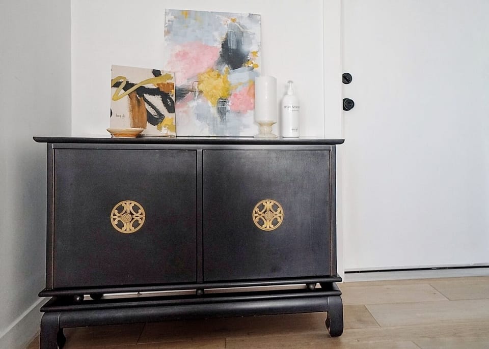 Entryway shoe cabinet and a guestbook on top of it.