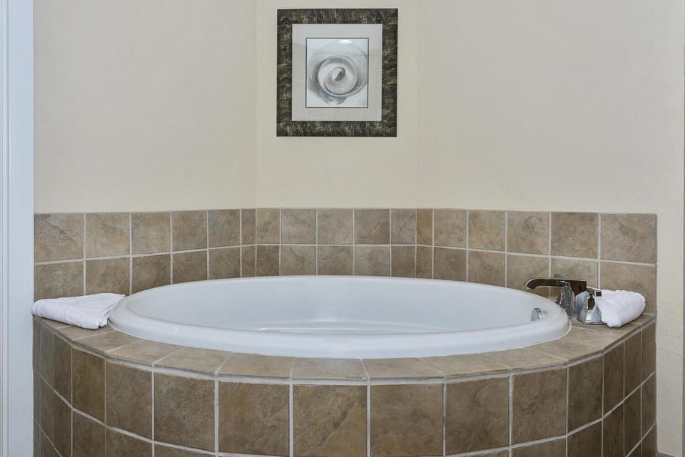 Sink into the large soaking tub, where warm tile surrounds you and fresh towels await your arrival.
