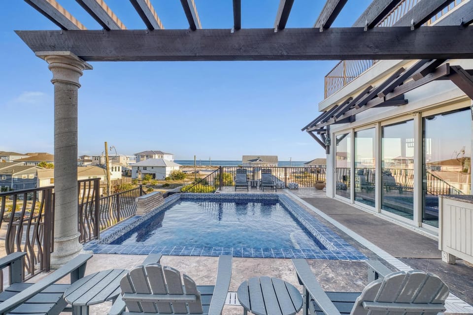 Your private rooftop oasis awaits with sparkling pool, ocean glimpses, and endless relaxation under sunny skies.