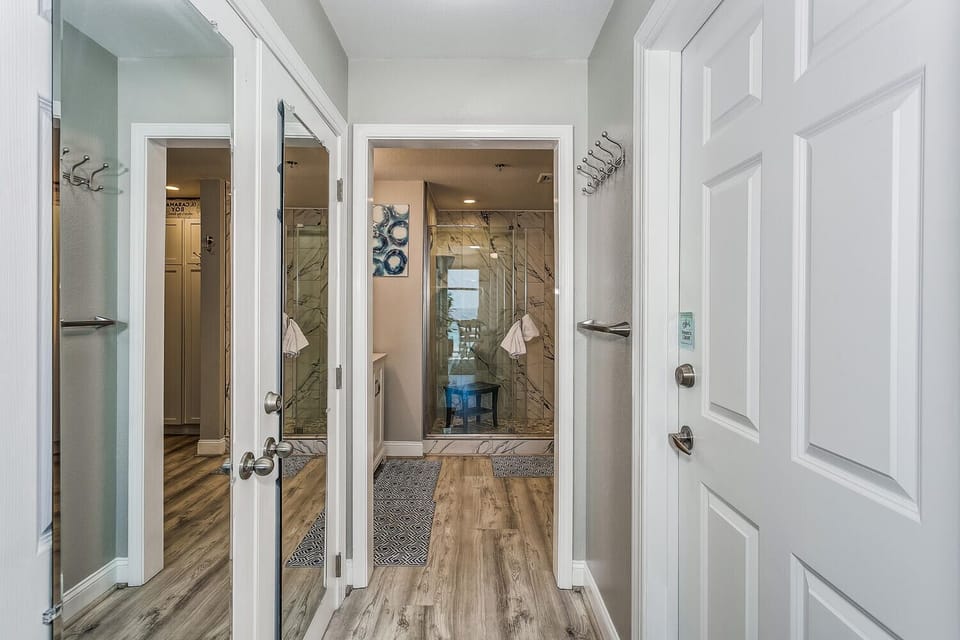 Coastal Cove - Primary hallway into bathroom