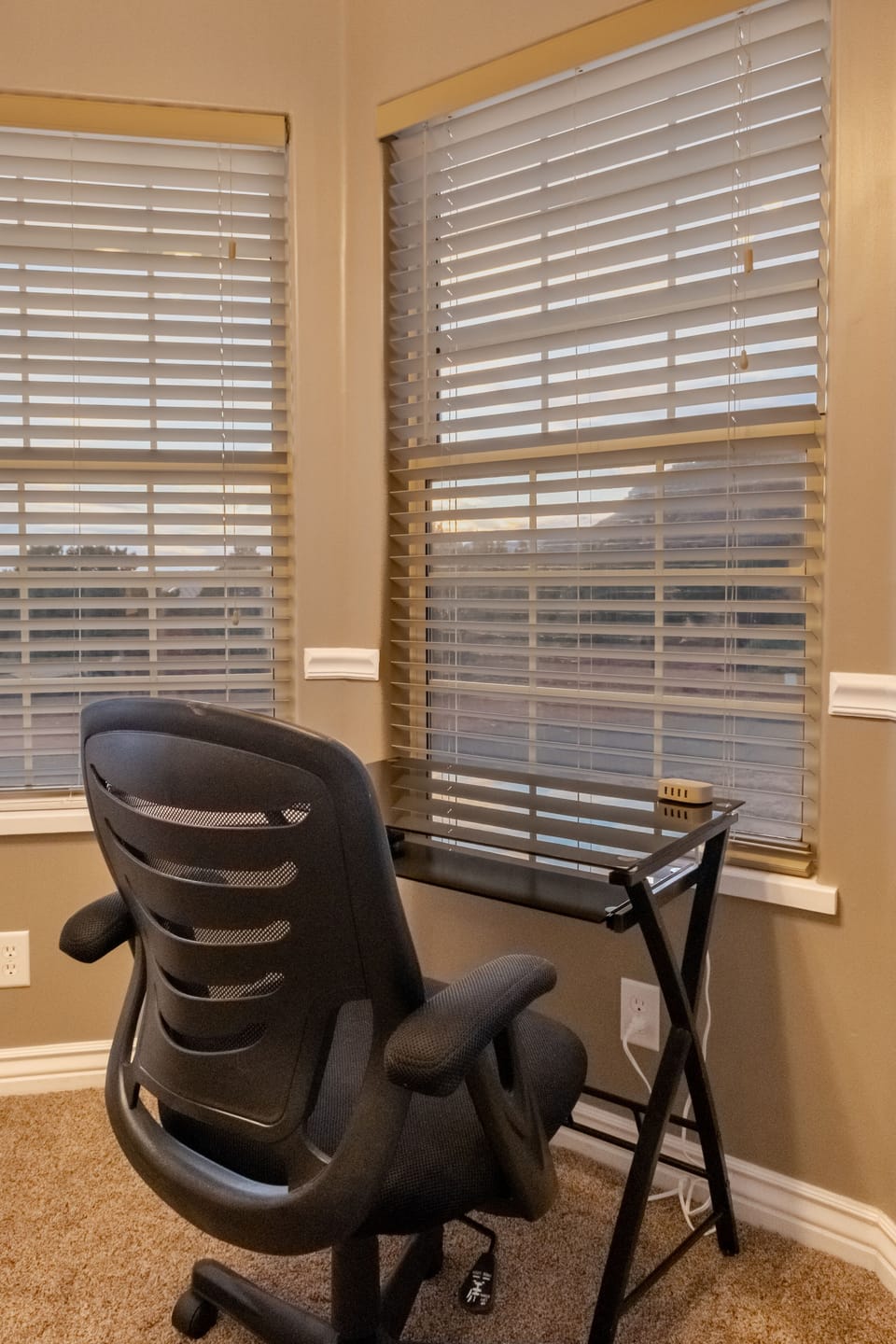 Master bedroom desk with chair overlooking mountain views.