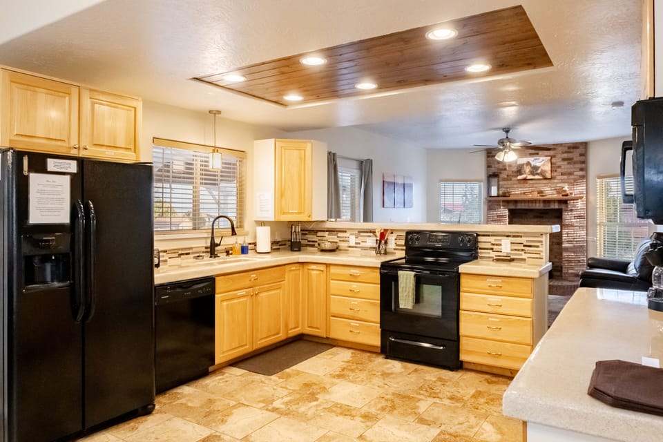 Kitchen area with dishes, pots and pans, coffee maker, toaster and more.