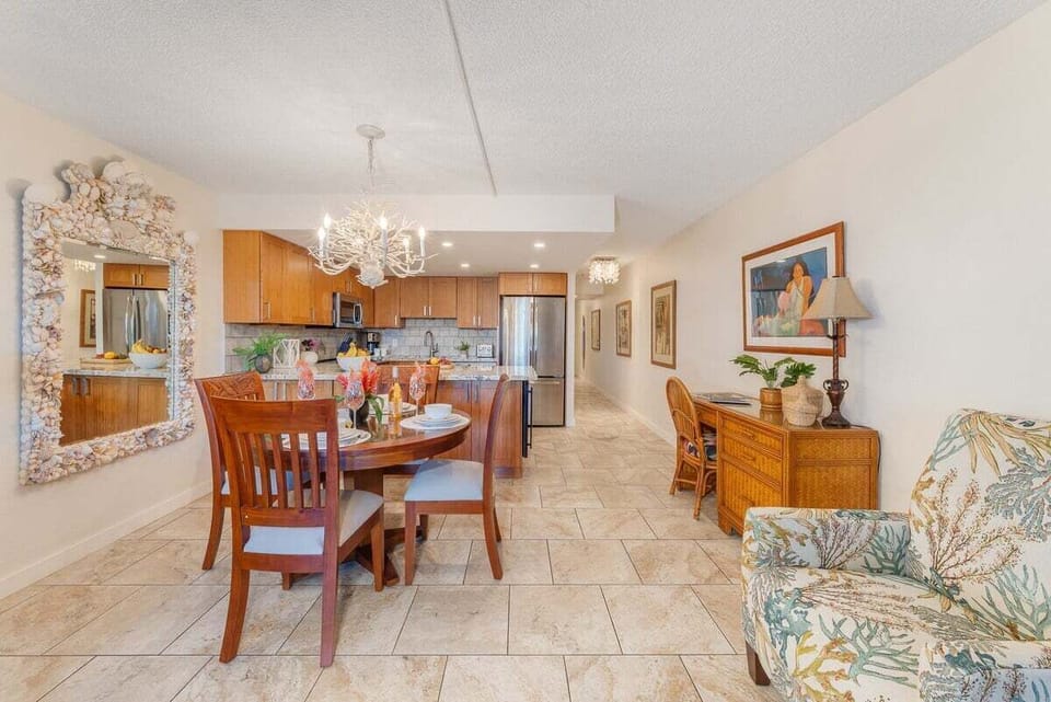 Stylish dining-kitchen combo offers warm wood cabinetry, beachy touches, and thoughtful workspace