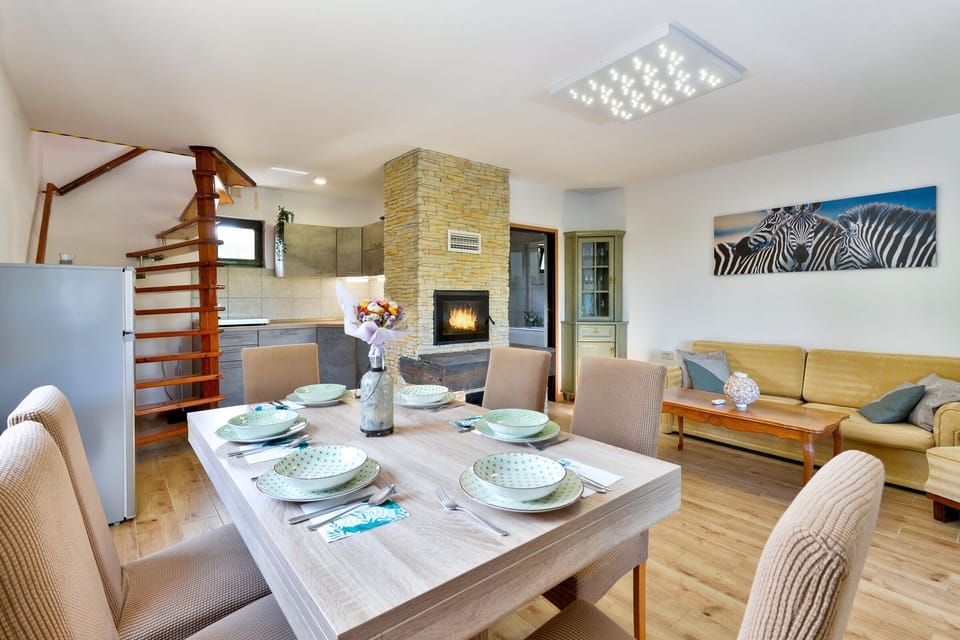 Dining table with living room and open kitchen