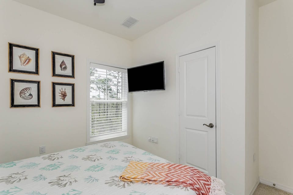 Guest bedroom with comfortable bedding and flat screen tv