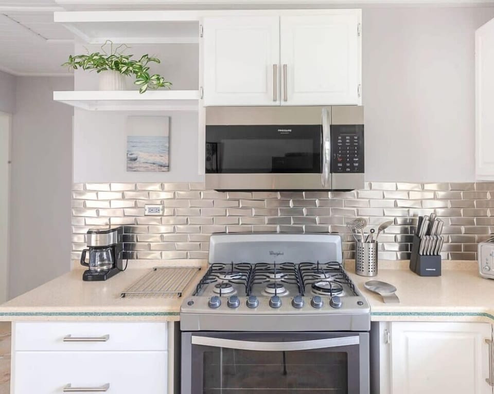 Enjoy the sleek new tile backsplash and high-quality appliances.