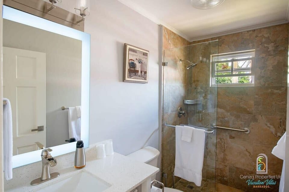 Enjoy a modern and spacious bathroom with a walk-in shower and sleek design.