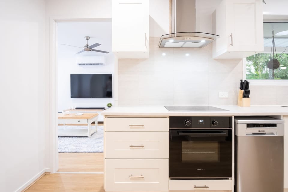 Oven, stove, and rangehood in the kitchen.
