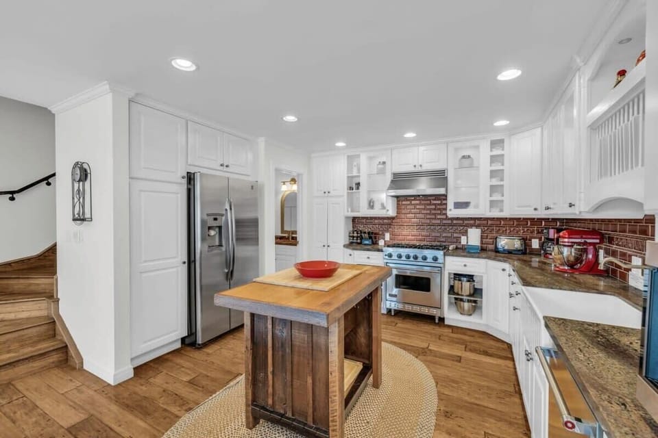 The kitchen features a full range of top-of-the-line stainless steel appliances and ample counter space making meal prep a breeze.