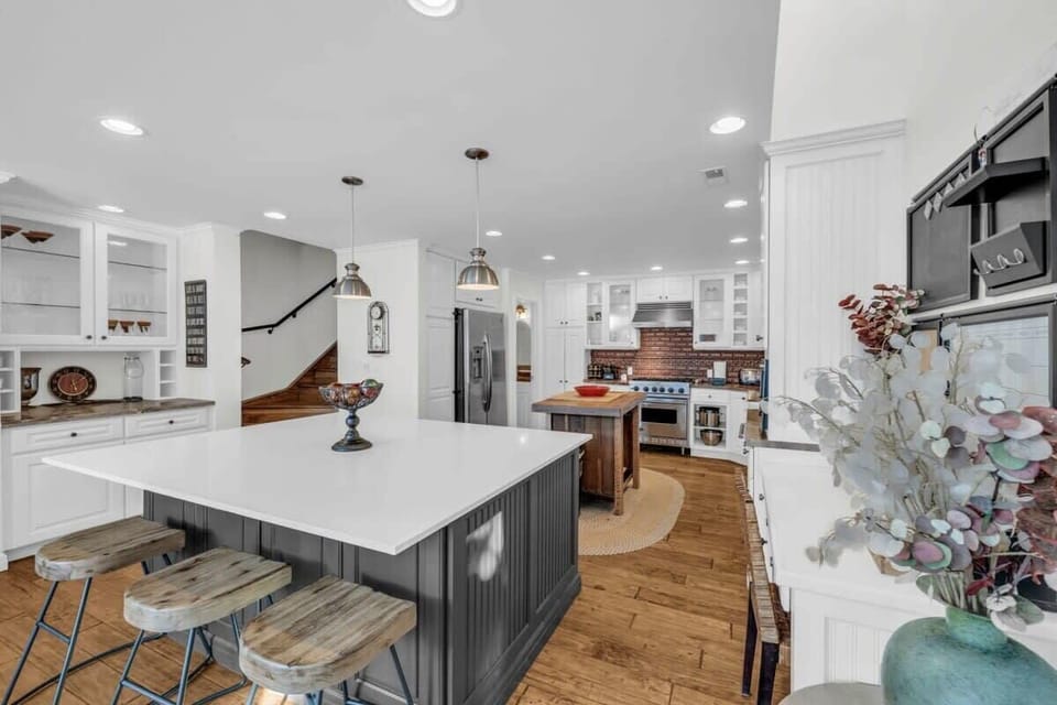 The spacious kitchen is fully equipped with top-of-the-line stainless steel appliances and includes a spacious kitchen island with seating for 3.