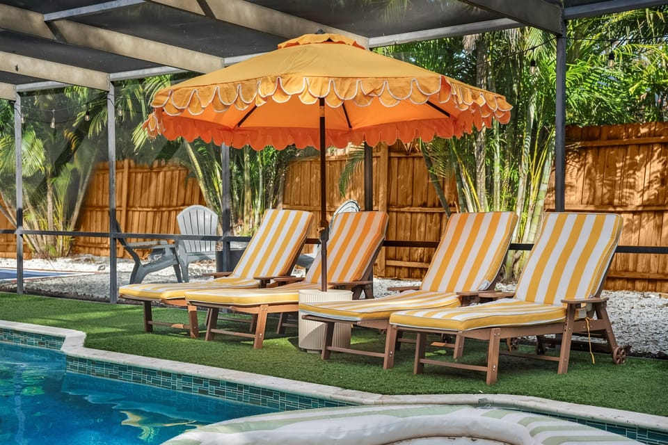 Covered and screened hot tub, ping pong, heated pool and patio.