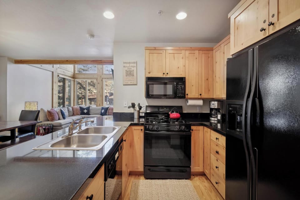 Kitchen: Well-equipped kitchen, drip coffee maker, open layout to living and dining room