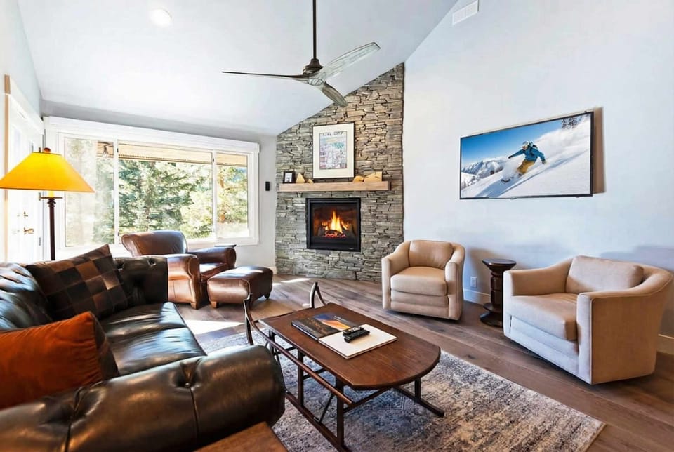 With its elegant furnishings, cozy seating spaces, stunning stone fireplace and large flat-screen TV, this living space welcomes you in to warm up, kick back and relax after a day on the slopes.