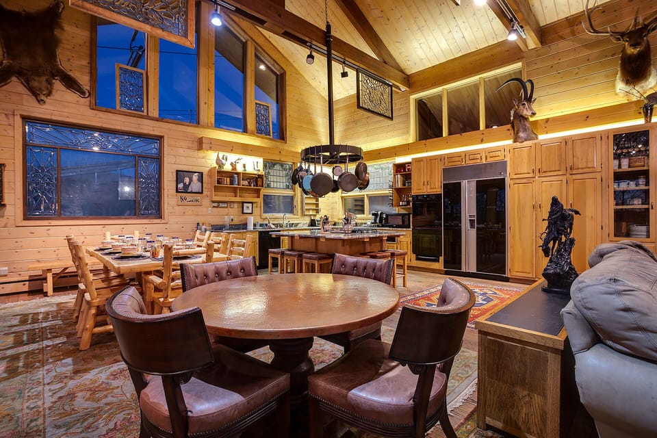 Gather around your rustic dining table or cozy up in the open kitchen, where warm wood beams and lodge-style charm create the perfect mountain retreat.