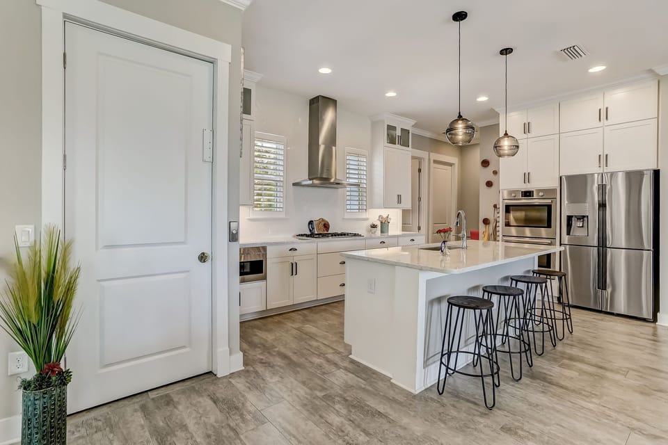 Luxury Fully Equipped Kitchen with Stainless Steel Appliances, Beautiful Quartz Countertops, Spacious Pantry, and Bar Stool Seating for 4