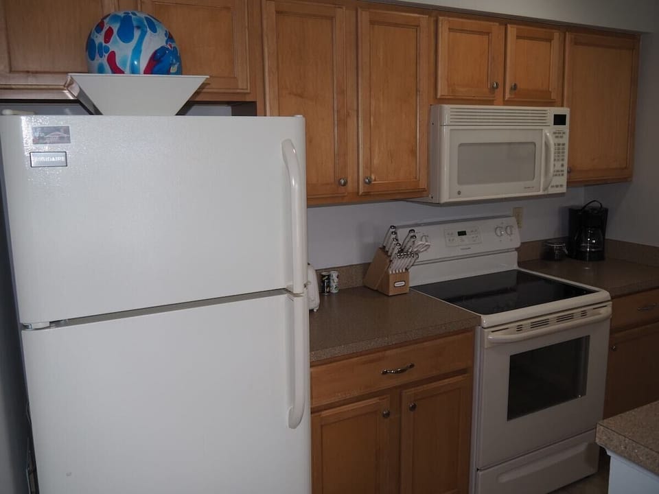KITCHEN:  The condo has a convenient and efficient full kitchen with all appliances including a dishwasher.  A good collection of cooking and dining utensils is also included with the rental.
