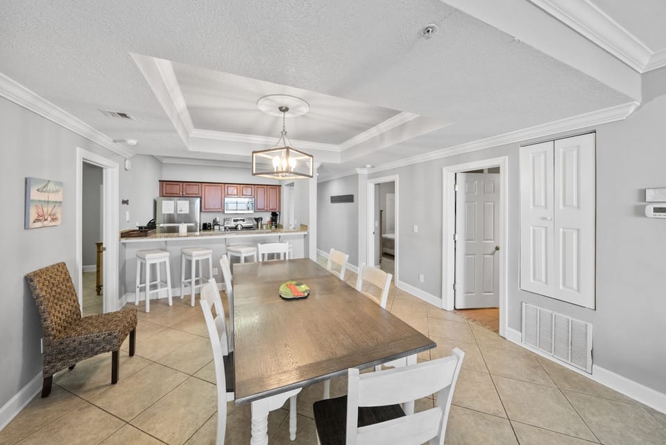 Gather around your elegant dining table beneath beautiful coffered ceilings, with the fully equipped kitchen just steps away for easy entertaining.