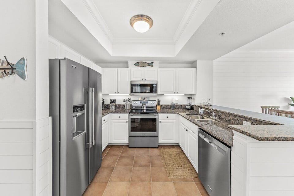Modern Elegance: Brand New Stainless Steel Appliances, Complete with a Refrigerator featuring an Ice Maker