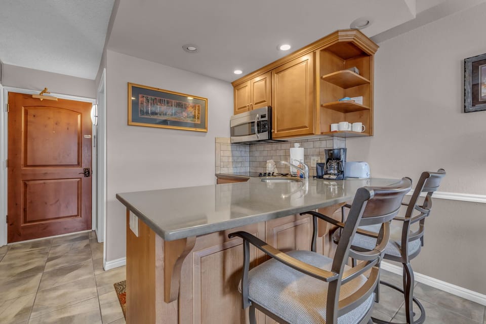 Fully-equipped kitchen with breakfast bar seating for up to 3