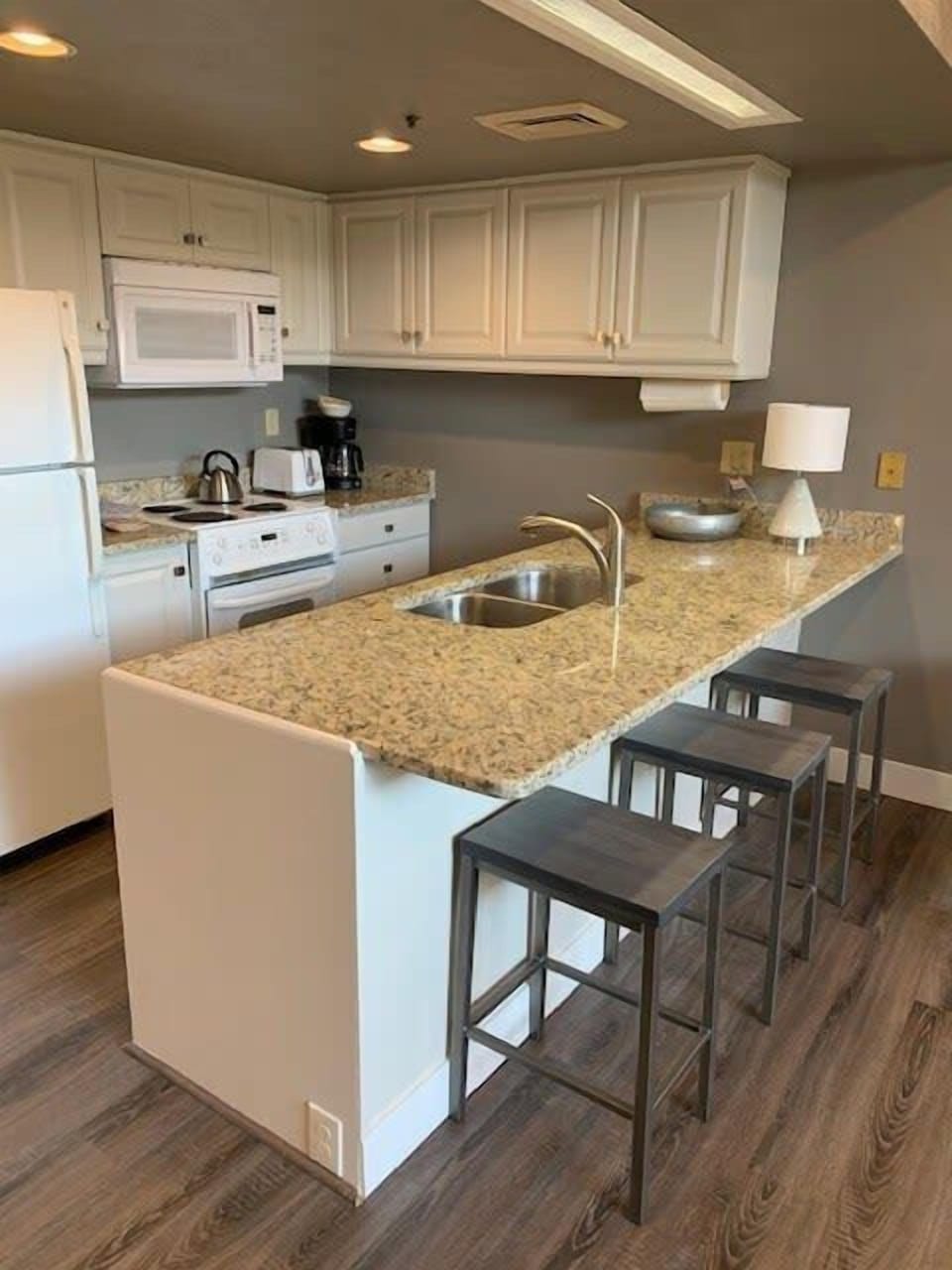 Fully-equipped kitchen with bar stool seating for 3