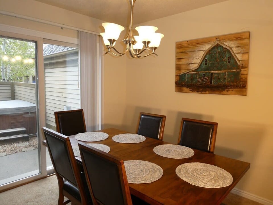 Dining area with seating for 6, and access to the private outdoor patio with a hot tub
