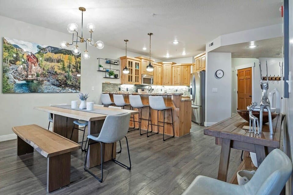 The stylish dining room features a table with seating for six conveniently located next to the kitchen where you will find a kitchen bar with additional seating for four.