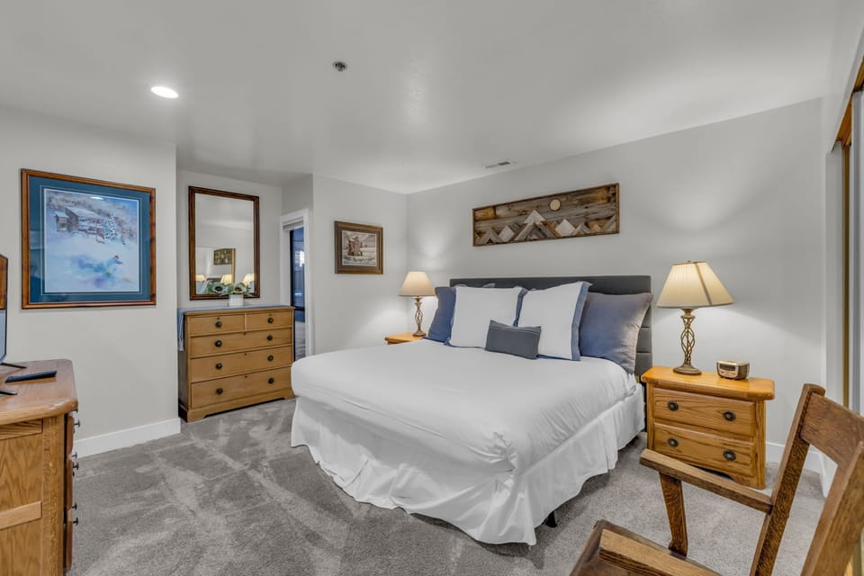 Bedroom 1: King bed, TV, dresser and closet storage, ensuite bathroom