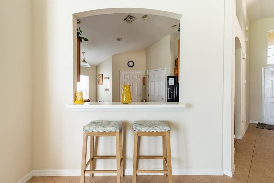 Bar for additional seating and a great passthrough to all the living spaces. 