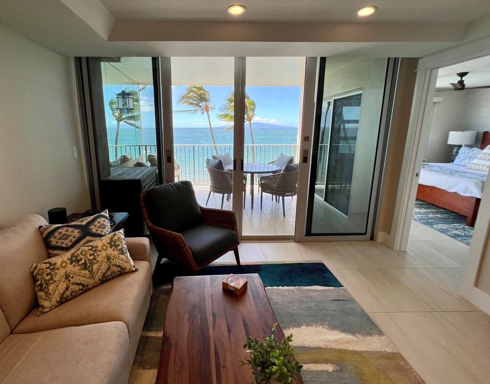 Living room with view to main bedroom and ocean lanai.