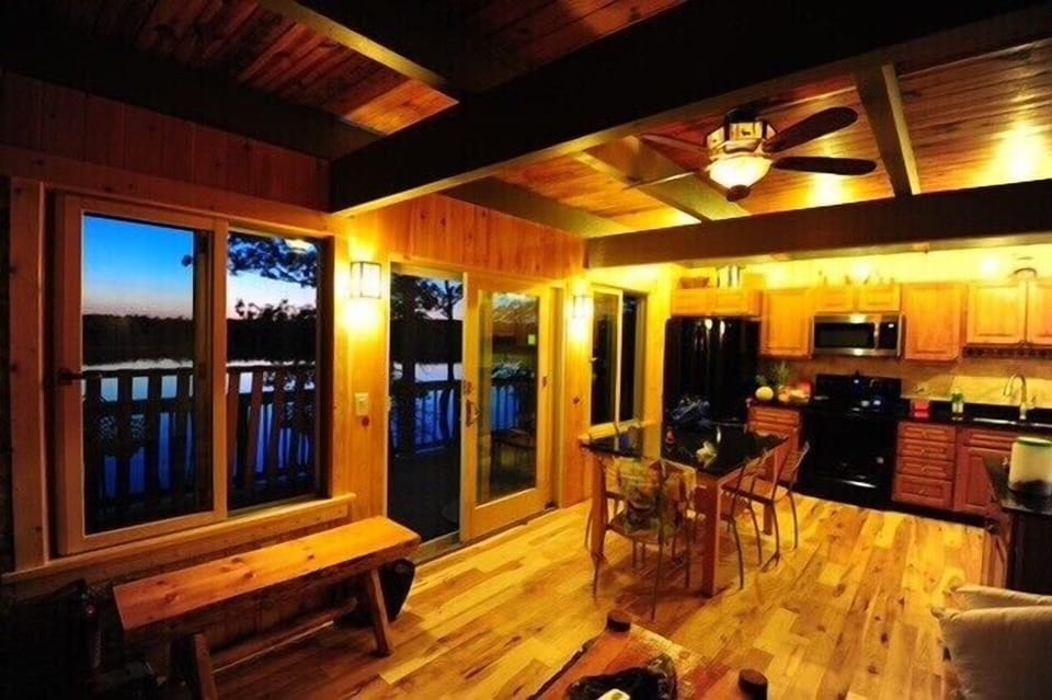Living room area looking into kitchen area, 6’ glass  slider leads to main deck 