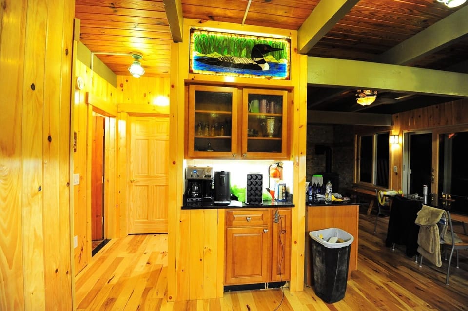 Coffee bar area and hallway, Hickory flooring, loon stained glass light on top