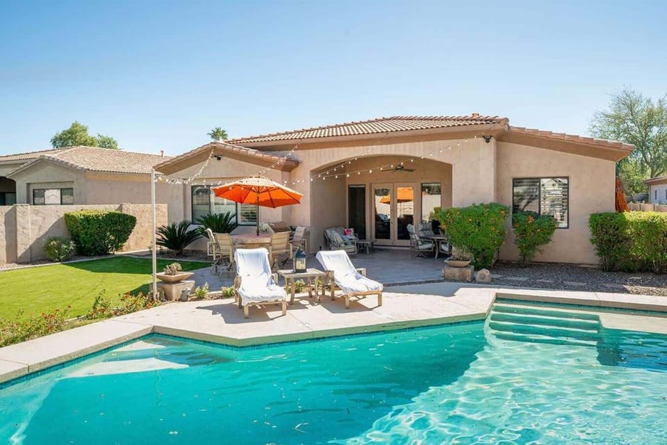 This beautiful backyard features an amazing pool and outdoor lounge areas for enjoying the incredible views of Arizona's tropical desert sunsets.