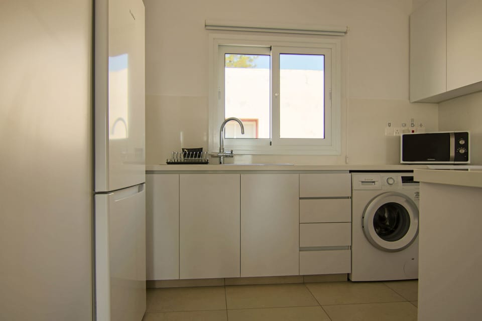 Deluxe Apartment | Private kitchen | Fridge, electric kettle, highchair, dining tables