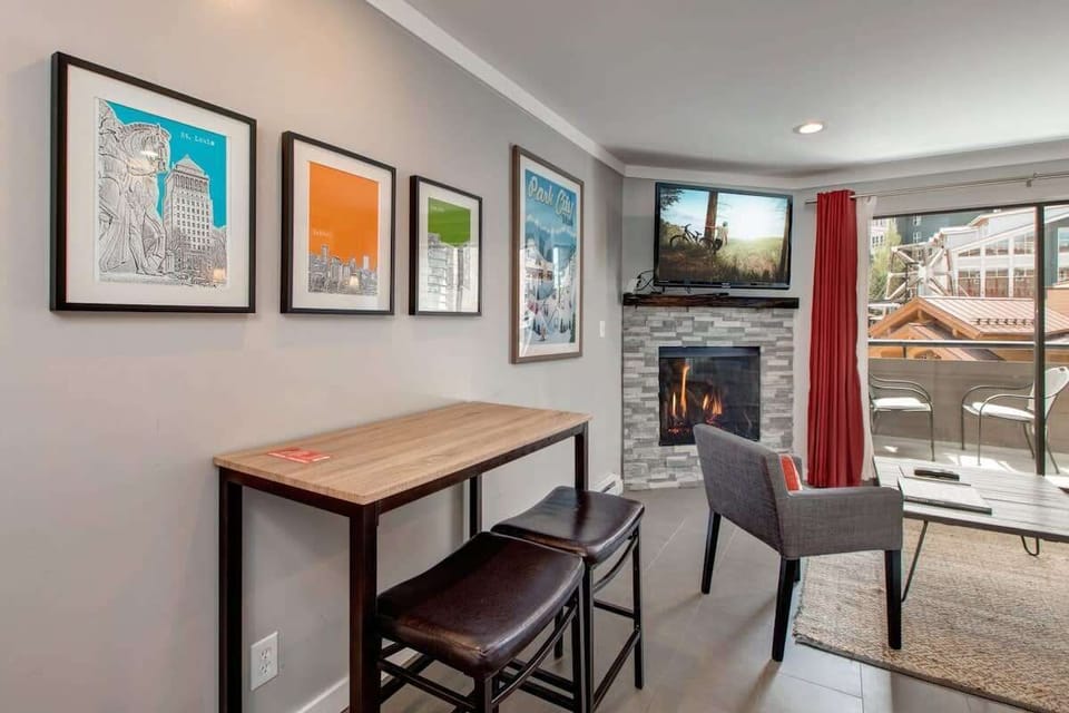 This charming dining area is conveniently located just off of the kitchen and can double as a desk/work space while keeping you within view of the fireplace and patio, with its mountain village views.