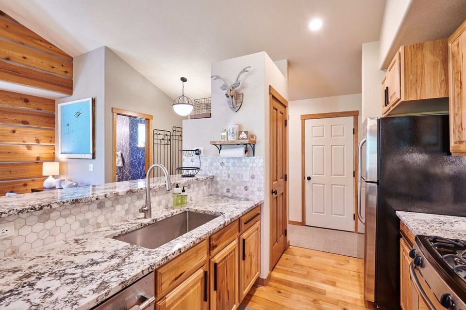 Fully stocked kitchen with dishwasher, fridge, gas range and microwave