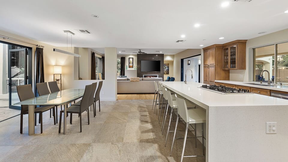 Chef’s kitchen opens to living room, perfect for gathering after desert days