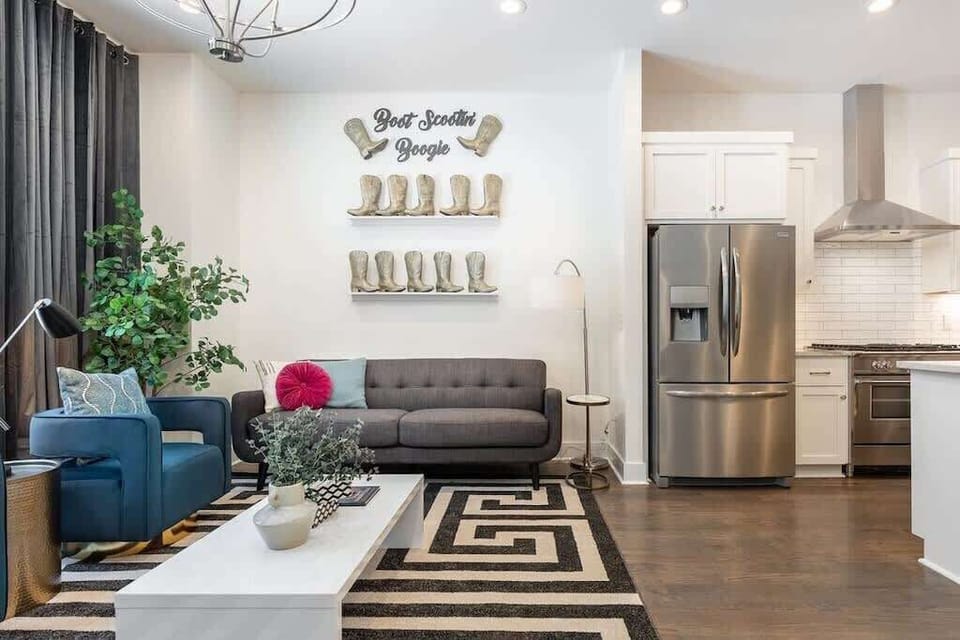 Living room with ample space, cozy feel, and cowboy boot touches.