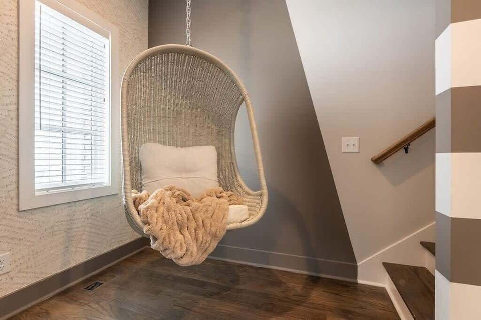 Swing into comfort in this charming space with a hanging egg chair.
