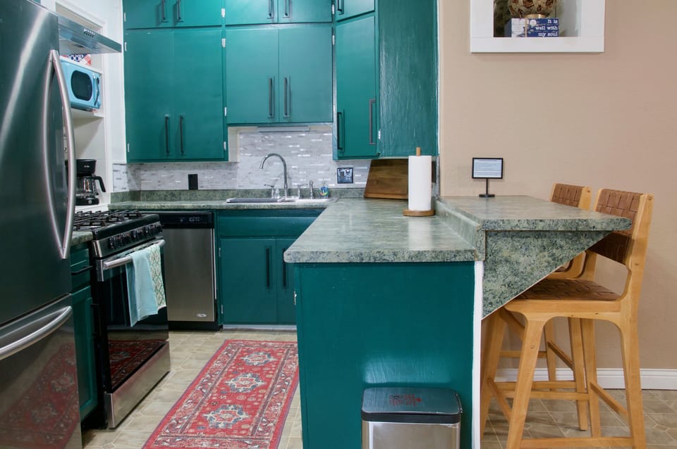 Fully stocked kitchen with stainless steel appliances and eat up bar 